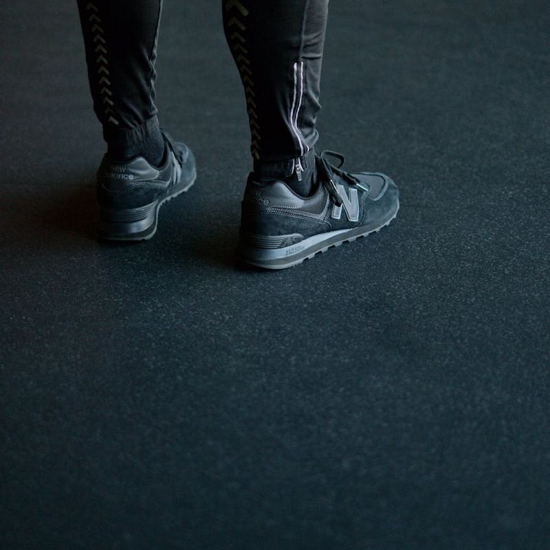 Close-up of athletic shoes on a dark floor before a workout session.